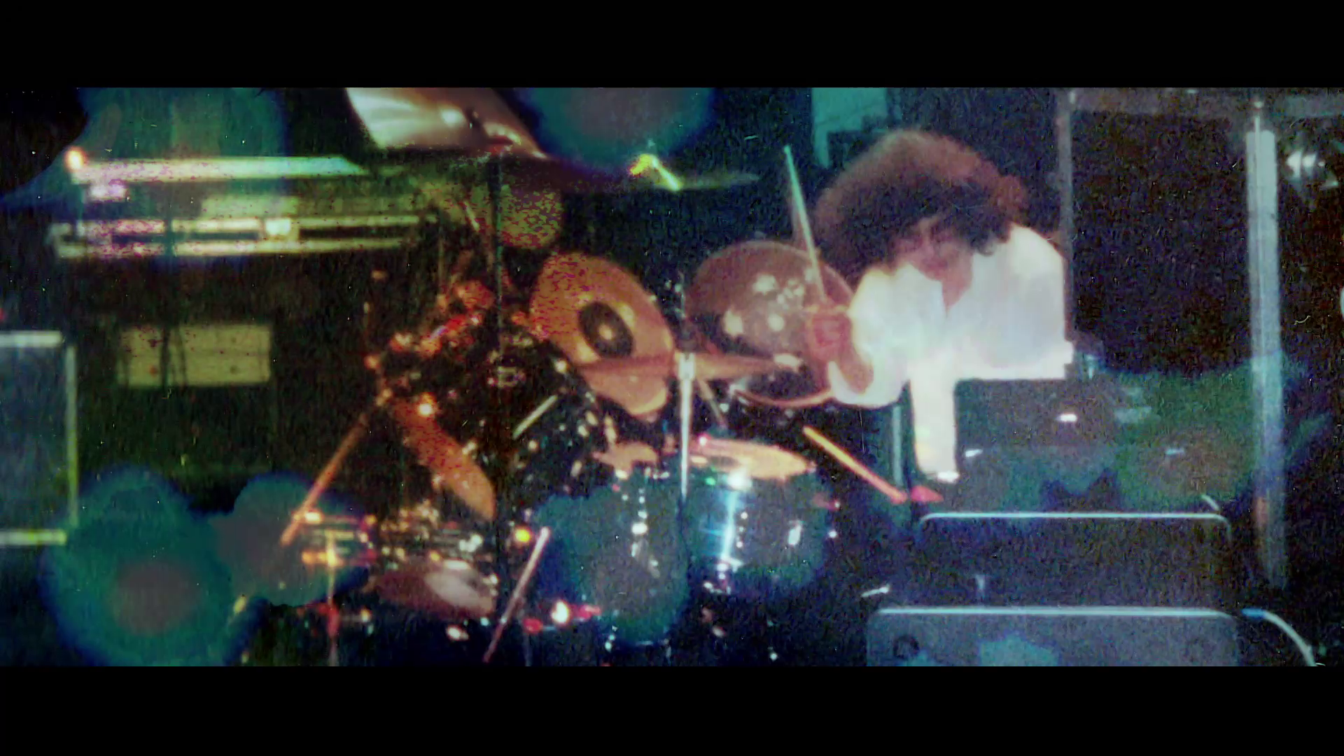 A grungy image of Dave Hickman playing the drums